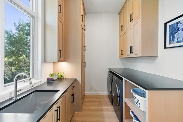 a kitchen with stainless steel appliances a sink a stove and a microwave