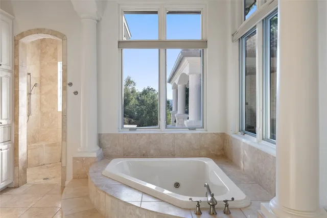 a bath tub sitting in a bathroom next to a window