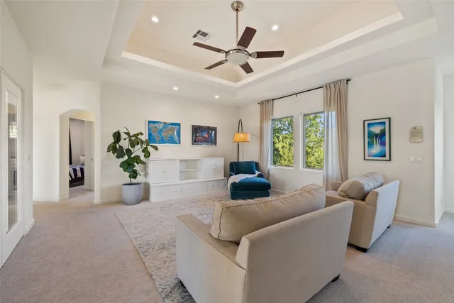 a living room with furniture and a large window with wooden floor