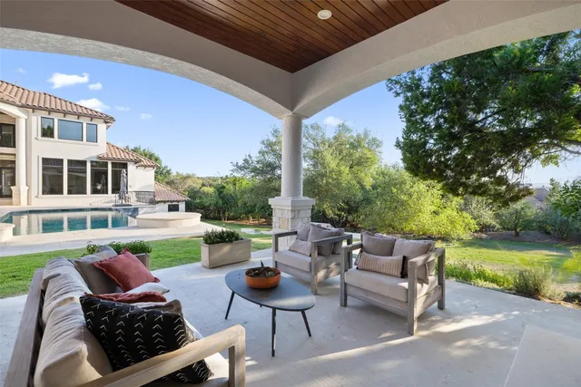 a view of a patio with couches chairs and a fire pit