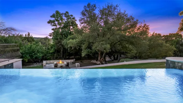 a view of a swimming pool with a yard