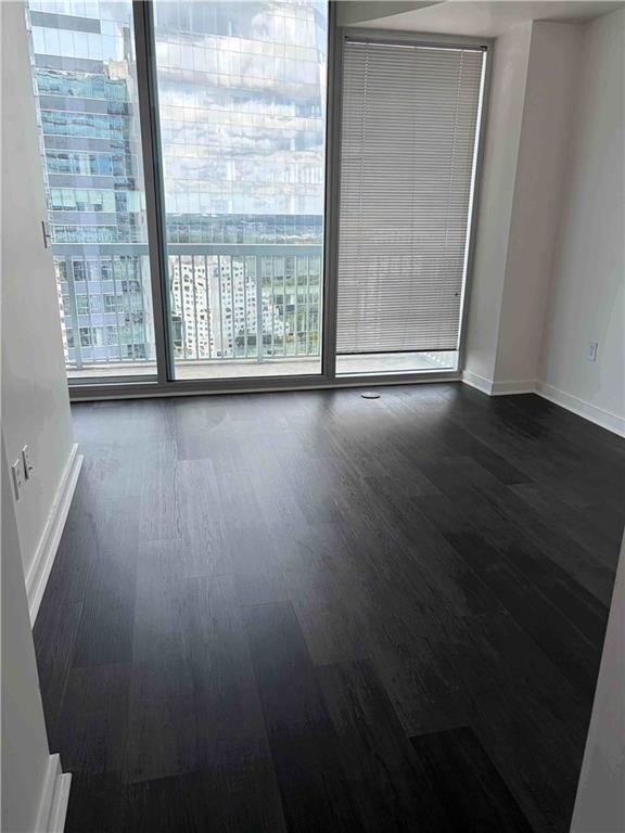 3324 Peachtree Road, Unit 2213 Atlanta, GA 30326 - Photo 5 of 28 an empty room with wooden floor and windows