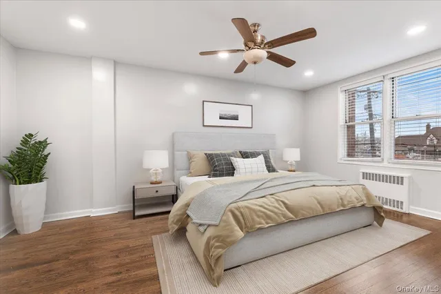 a bedroom with a large bed and a potted plant