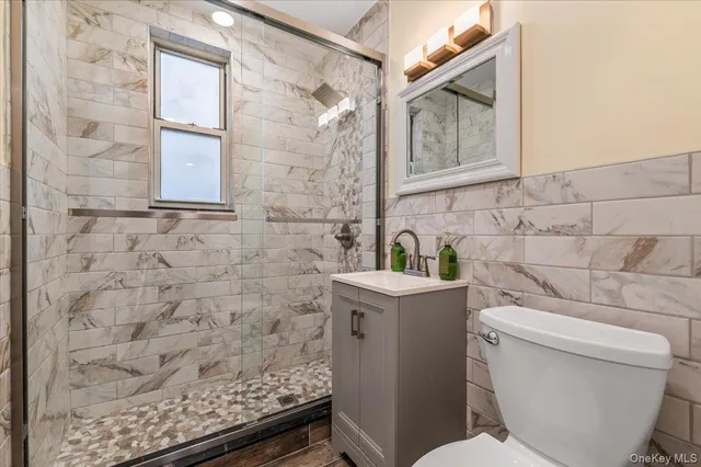 a bathroom with a toilet and a shower