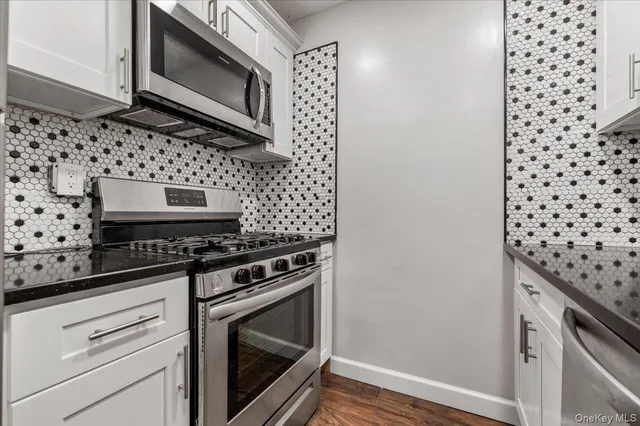 a kitchen with granite countertop cabinets and steel stainless steel appliances