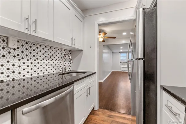 a view of a kitchen cabinets and a refrigerator