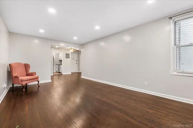 a view of a room with wooden floor and a window