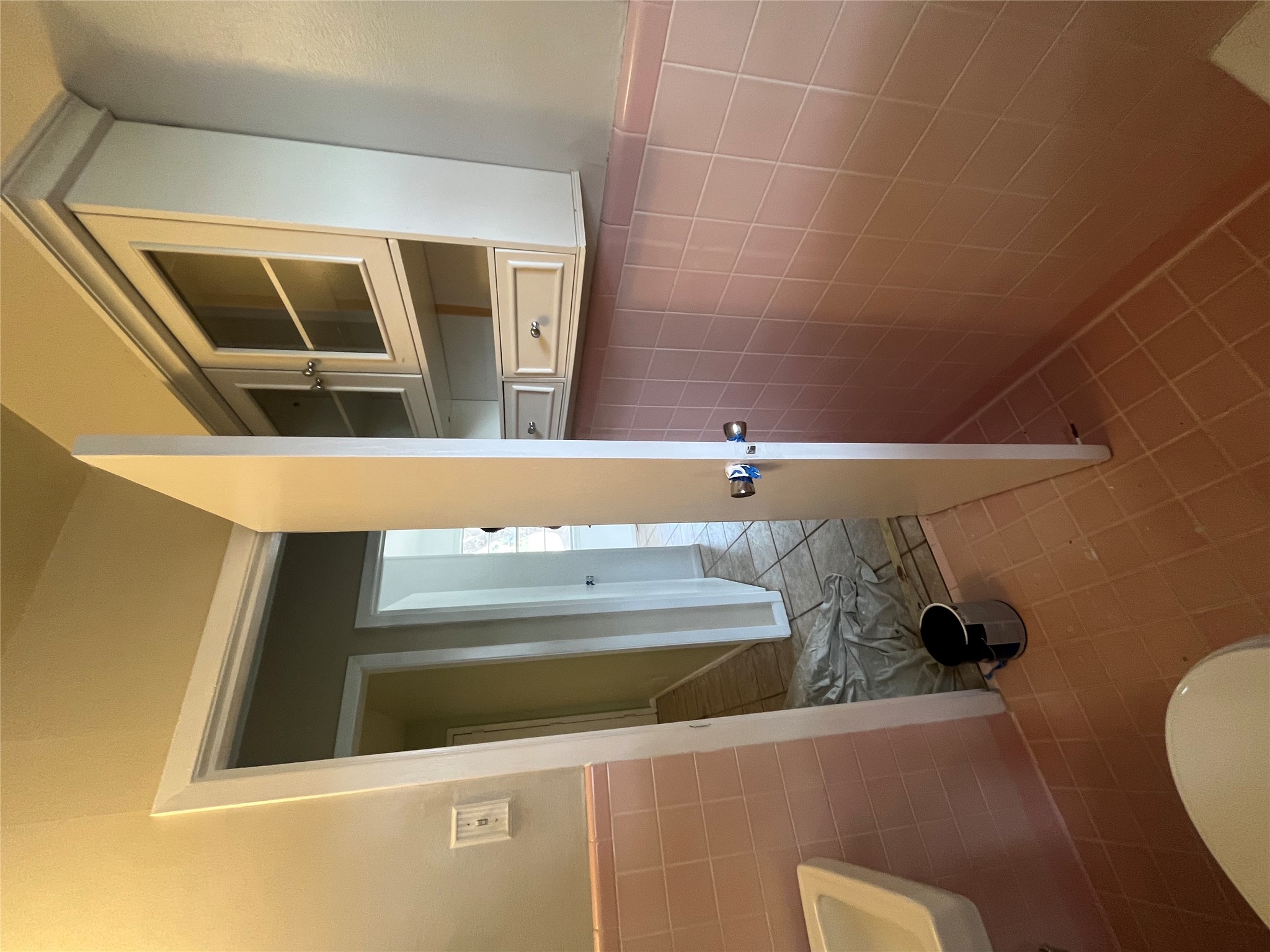 1607 Lightsey Road, Unit A Austin, TX 78704 - Photo 11 of 17 White wall-mounted cabinetry with glass-front upper doors and lower drawers