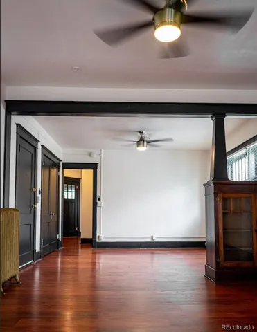 a kitchen with a table chairs and refrigerator