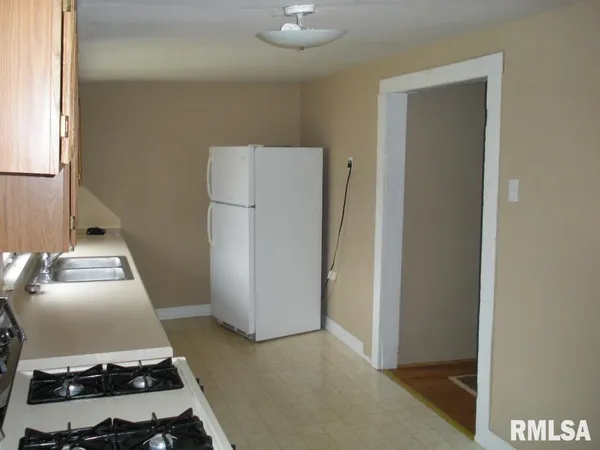 a kitchen that has a sink and a stove