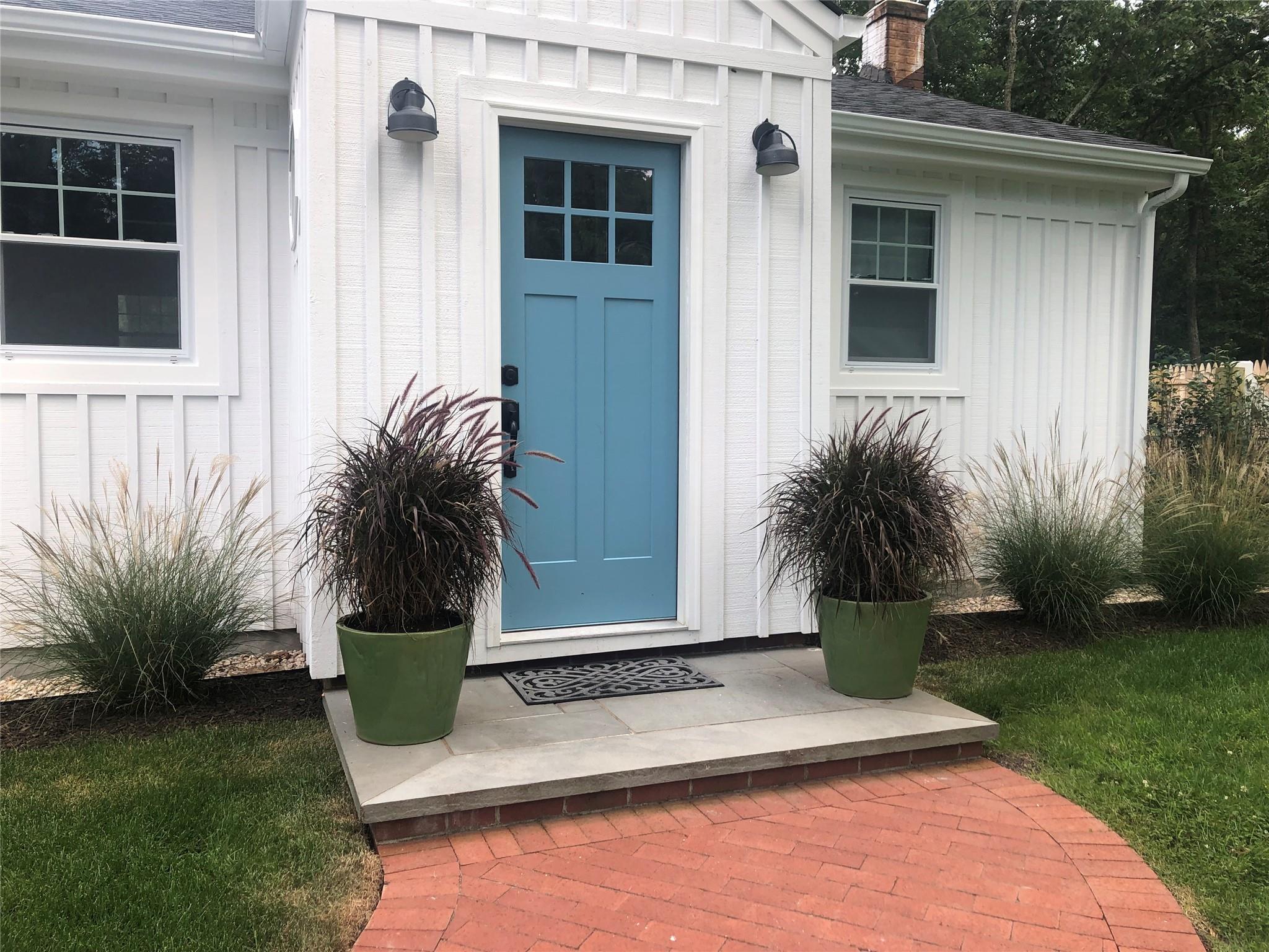 Property entrance featuring a chimney and roof with shingles