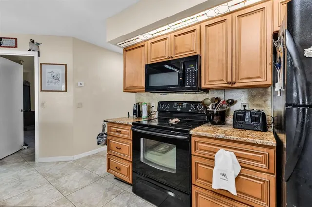 a kitchen with stainless steel appliances granite countertop a stove and a microwave