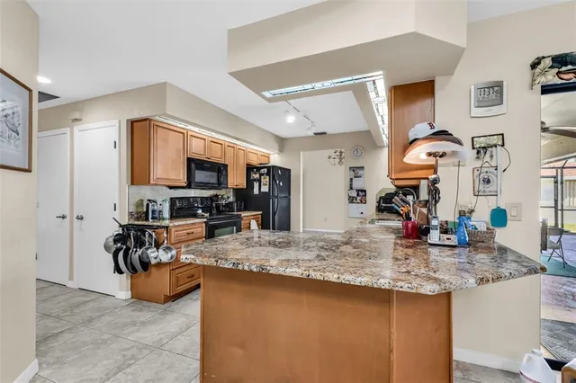 a kitchen view with granite countertop a stove and a sink