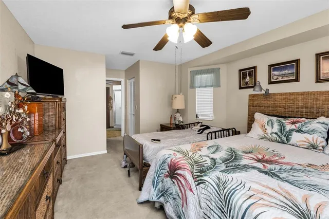 a bedroom with bed and a flat tv screen