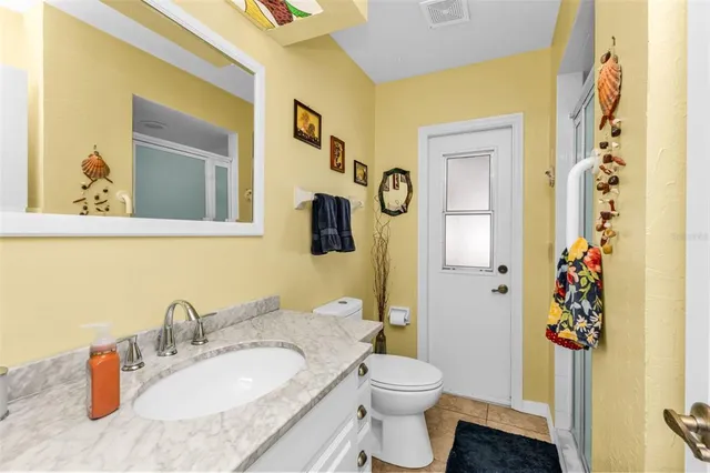a spacious bathroom with a granite countertop sink toilet and shower