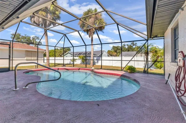a view of a backyard with swimming pool