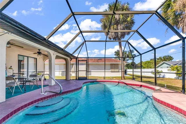 a view of a swimming pool with an outdoor seating