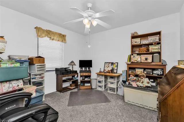 a reading room with furniture and a flat screen tv