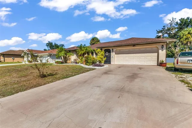 a view of a house with a yard and garage