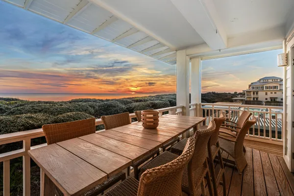 a view of a balcony with table and chairs