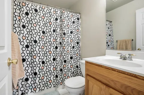 a bathroom with a sink toilet and a mirror