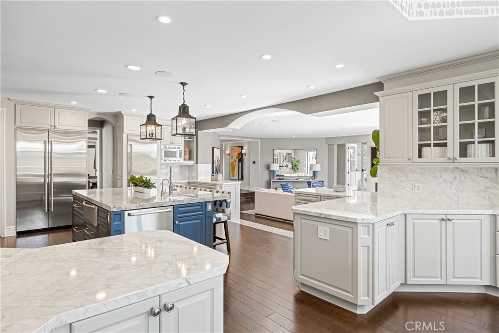 1240 5th Street Manhattan Beach, CA 90266 - Photo 11 of 68 a kitchen with stainless steel appliances kitchen island granite countertop a table chairs and a refrigerator