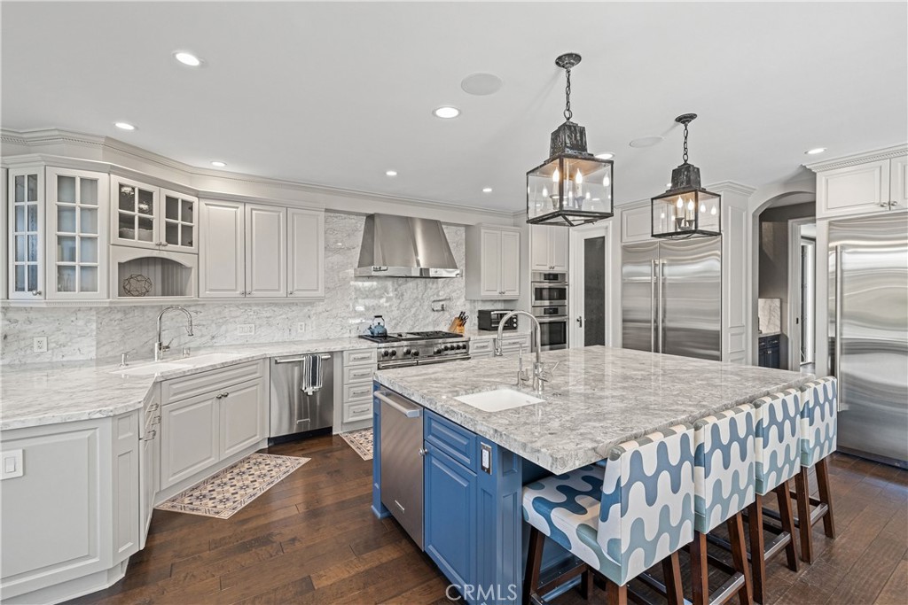 1240 5th Street Manhattan Beach, CA 90266 - Photo 12 of 68 a kitchen with granite countertop a center island and stainless steel appliances