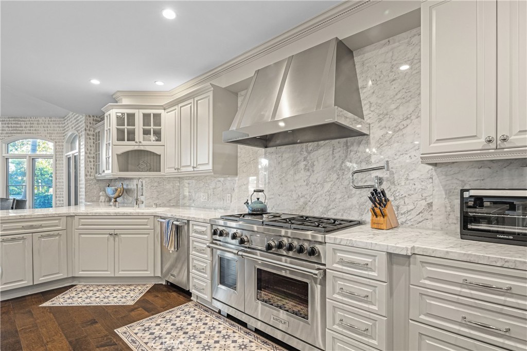 1240 5th Street Manhattan Beach, CA 90266 - Photo 17 of 68 a kitchen with stainless steel appliances a stove a sink and cabinets