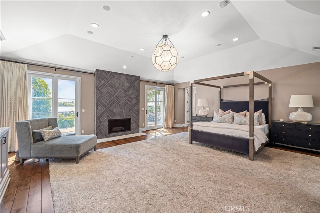 1240 5th Street Manhattan Beach, CA 90266 - Photo 30 of 68 a spacious bedroom with a bed and a fireplace