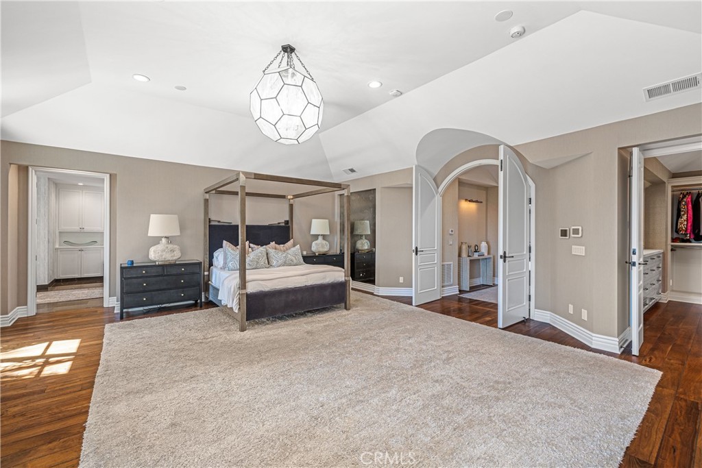 1240 5th Street Manhattan Beach, CA 90266 - Photo 32 of 68 a bedroom with a large bed and a chandelier