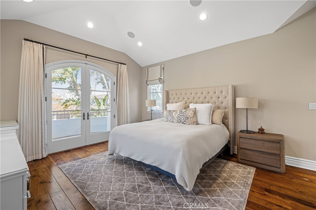 1240 5th Street Manhattan Beach, CA 90266 - Photo 51 of 68 a spacious bedroom with a bed and wooden floor