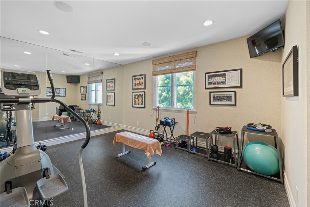 1240 5th Street Manhattan Beach, CA 90266 - Photo 55 of 68 a living room with furniture gym equipment and a flat screen tv