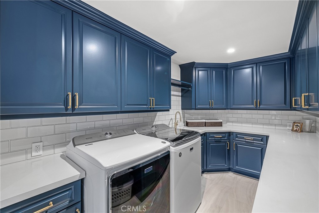 1240 5th Street Manhattan Beach, CA 90266 - Photo 56 of 68 a kitchen with a sink cabinets and stainless steel appliances