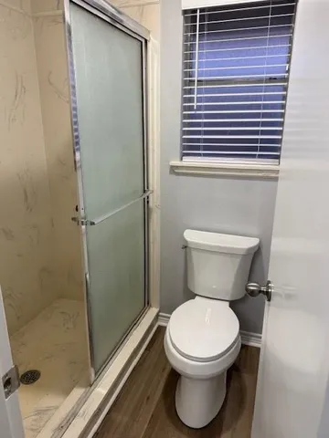 a bathroom with a double vanity sink mirror and toilet