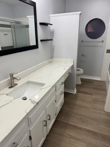 a bathroom with a glass shower door