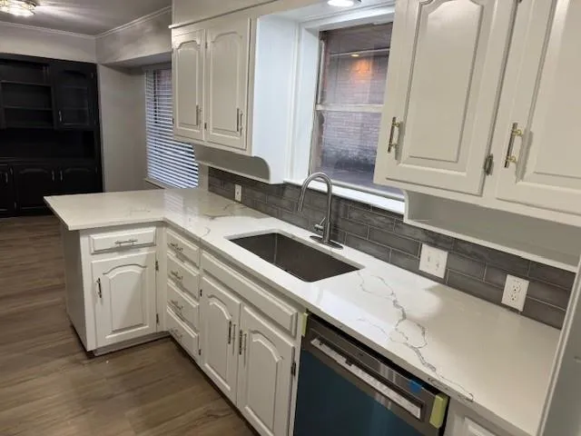 a kitchen with a sink and cabinets