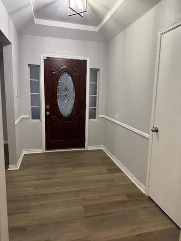 a view of a hallway with wooden floor