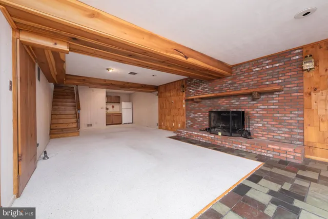 a view of an empty room with a fireplace