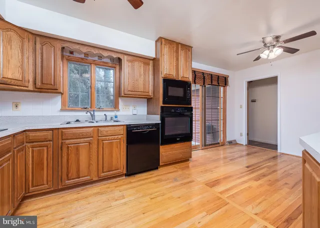 a kitchen with stainless steel appliances granite countertop a sink and cabinets