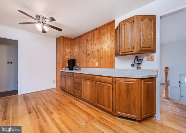 a kitchen with stainless steel appliances granite countertop a sink dishwasher cabinets and wooden floor