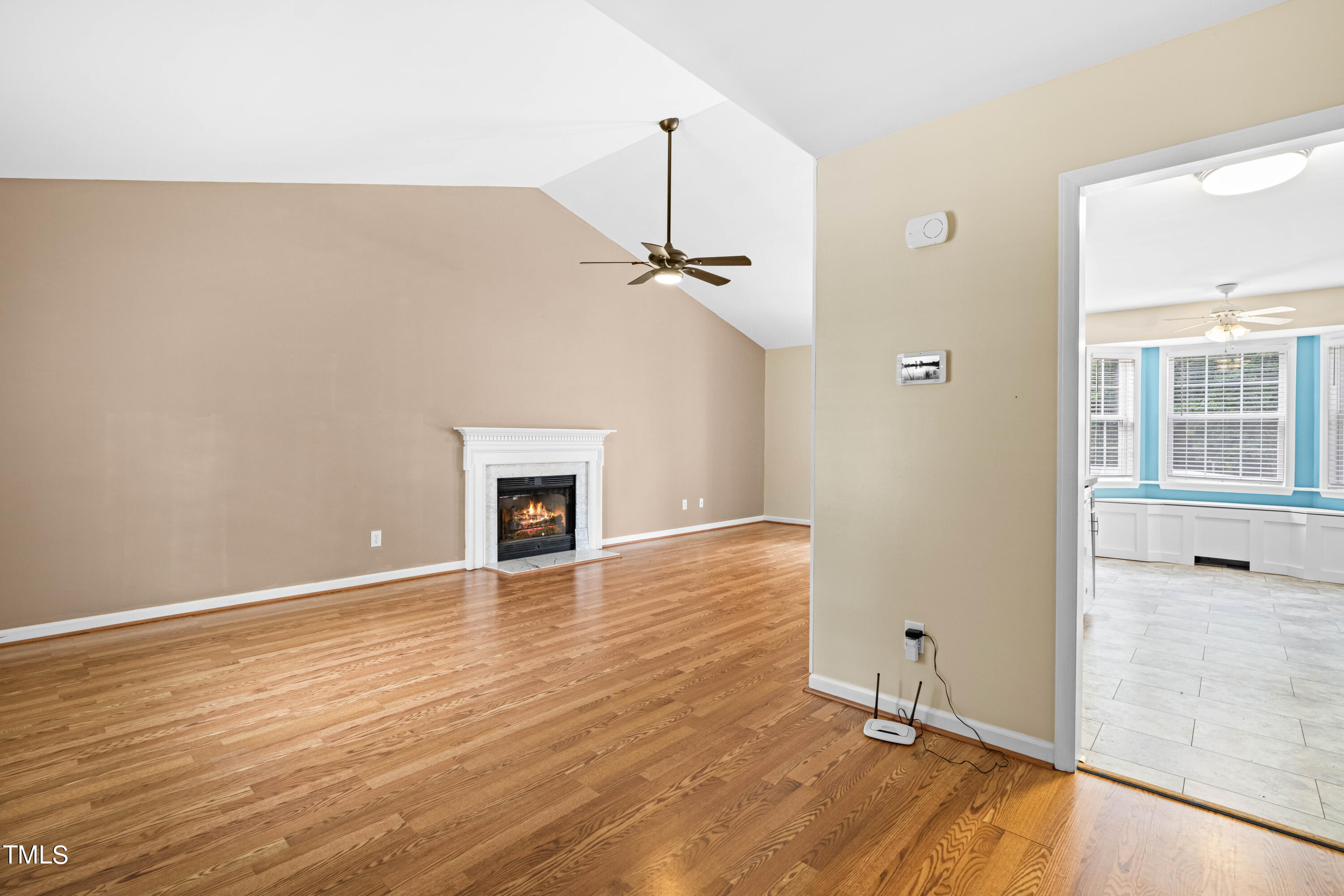 320 Amber Lane Willow Spring, NC 27592 - Photo 2 of 16 a view of a room with wooden floor and a ceiling fan