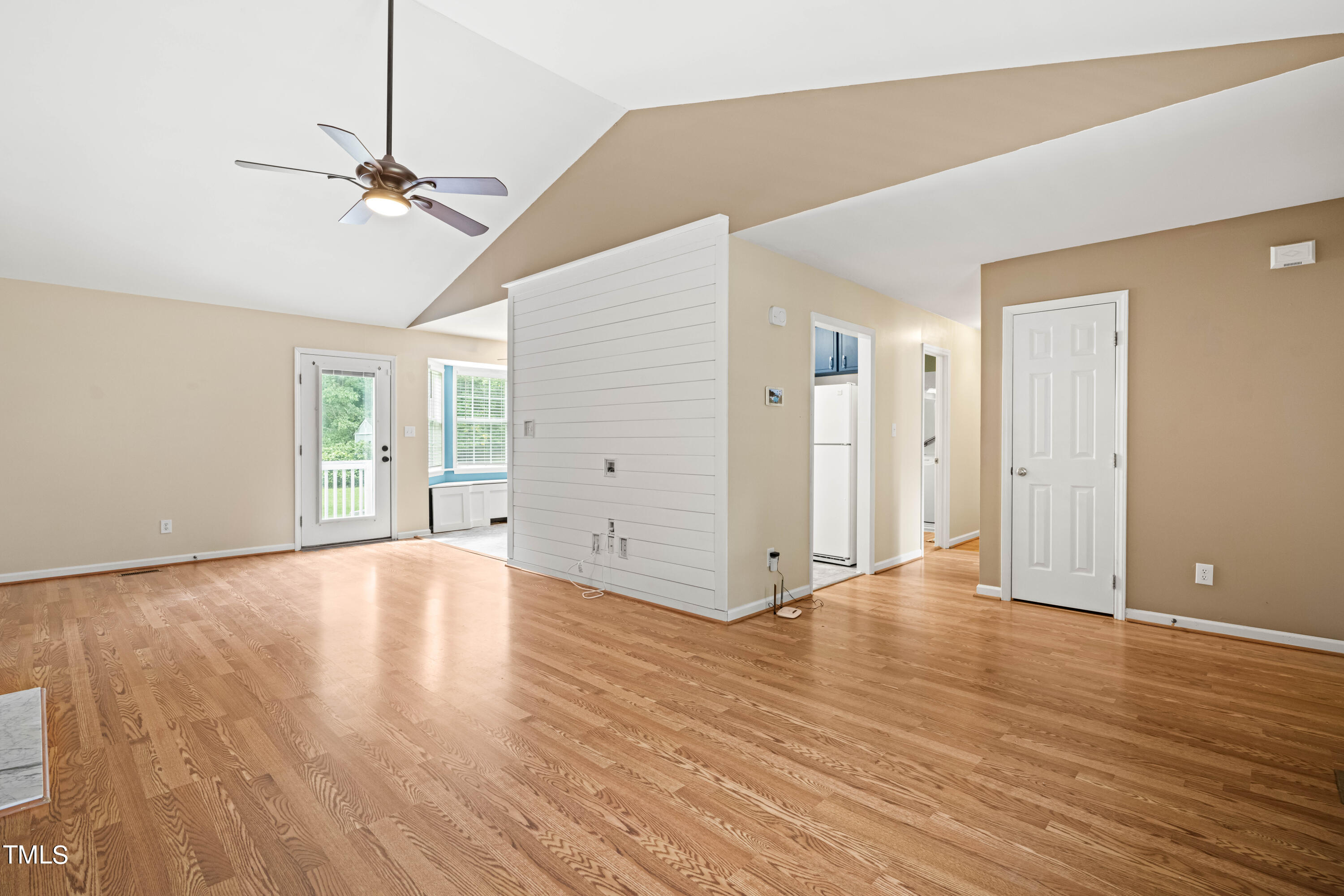 320 Amber Lane Willow Spring, NC 27592 - Photo 3 of 16 a view of an empty room with wooden floor and a window