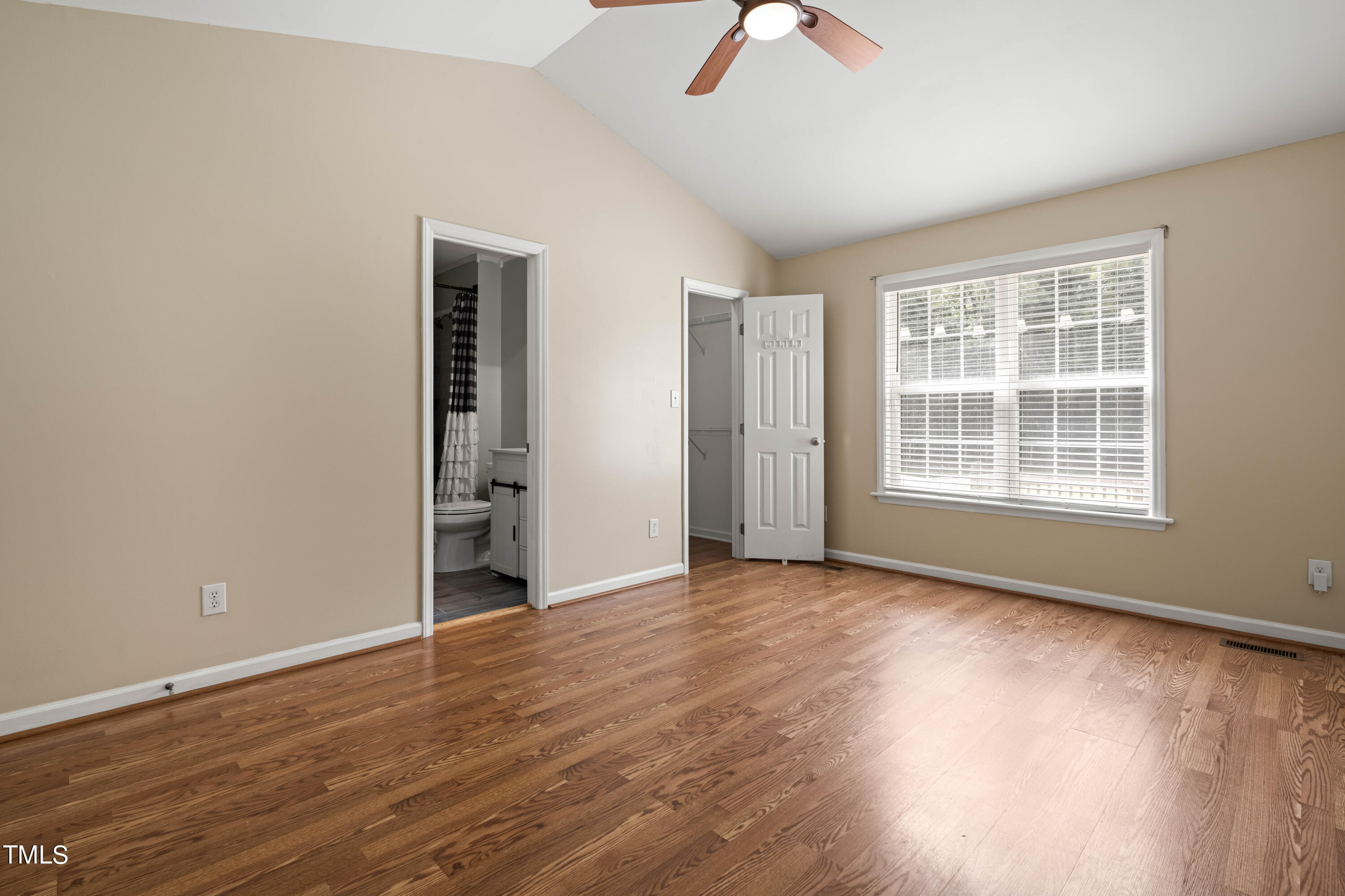 320 Amber Lane Willow Spring, NC 27592 - Photo 7 of 16 an empty room with wooden floor and windows
