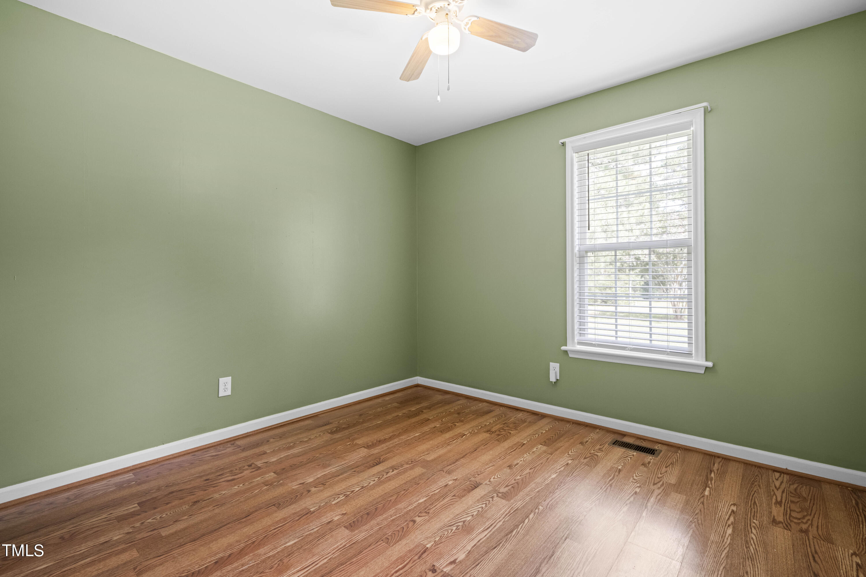 320 Amber Lane Willow Spring, NC 27592 - Photo 10 of 16 a view of a room with wooden floor and windows