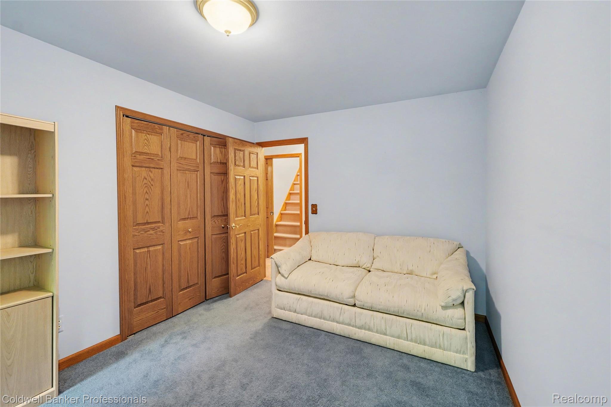3583 Mitchell Road Metamora, MI 48455 - Photo 41 of 58 Room featuring light blue walls, gray carpeting, and wooden trim