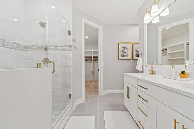a spacious bathroom with a shower sink and mirror