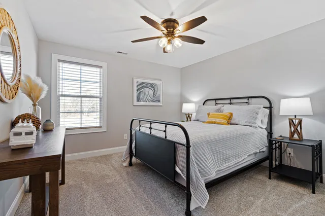 a bedroom with a bed and a chandelier