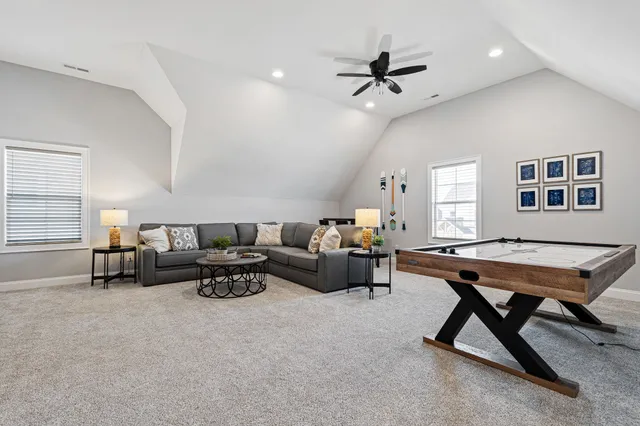 a living room with furniture a rug and a window