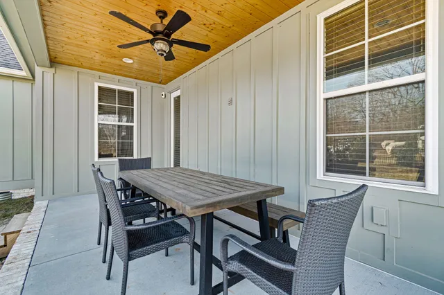 a view of a dining room with furniture and a window