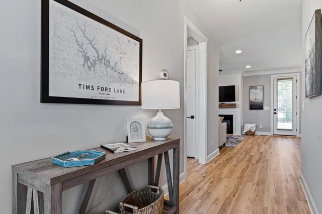 a kitchen with stainless steel appliances a stove refrigerator and a wooden floor
